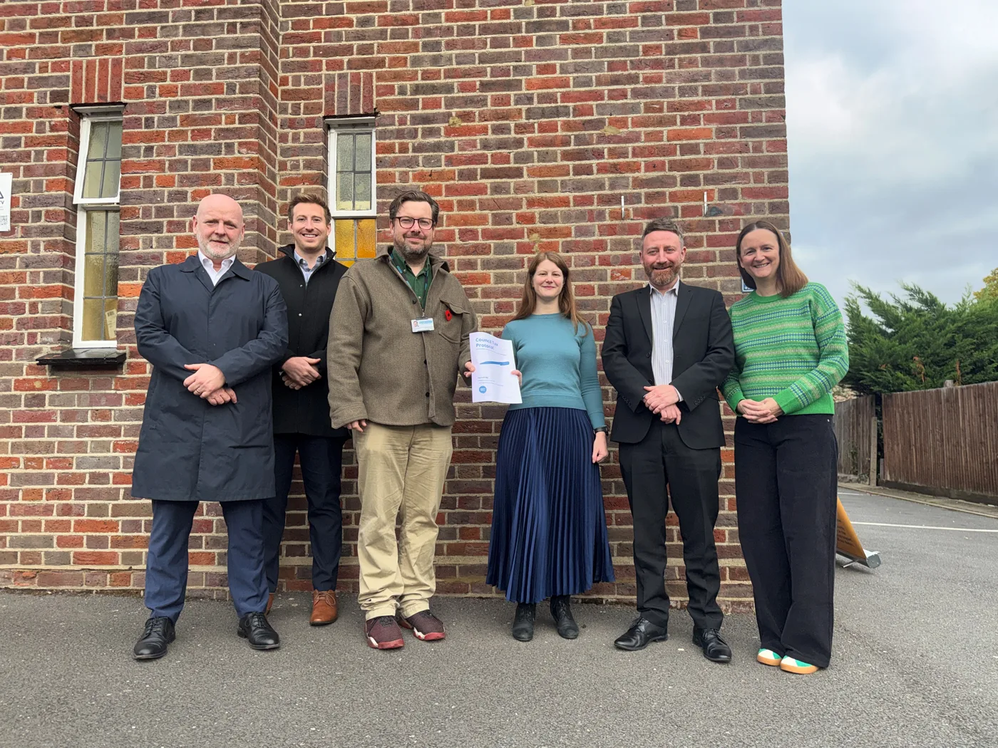 A copy of the Council Tax Protocol held up at the signing at Chipping Barnet Foodbank