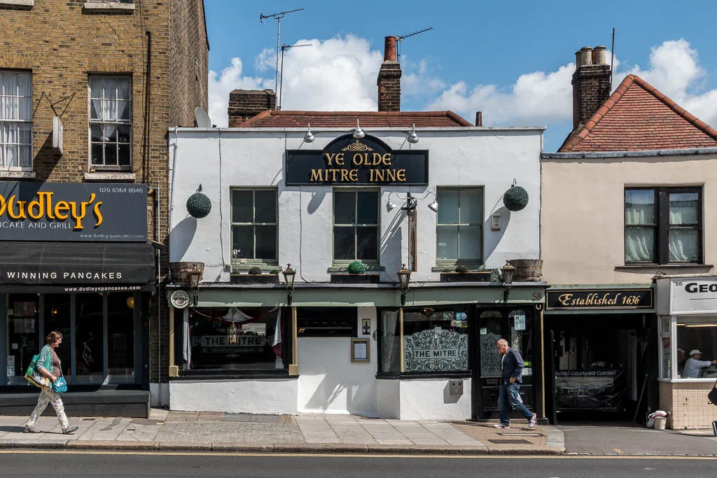 Ye Olde Mitre Inne on High Street, Barnet, with its "Established 1636" sign next door