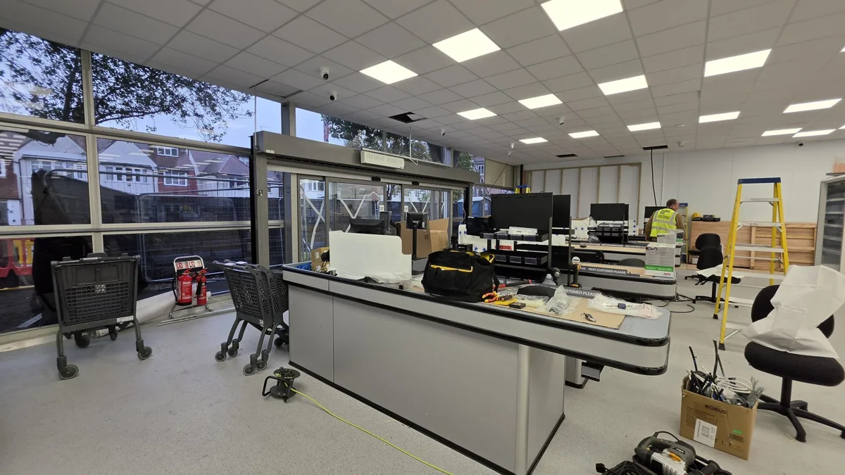 Inside the new Kosher Kingdom store on Golders Green Road during fit-out, with checkout counters, trolleys and a large glass shopfront