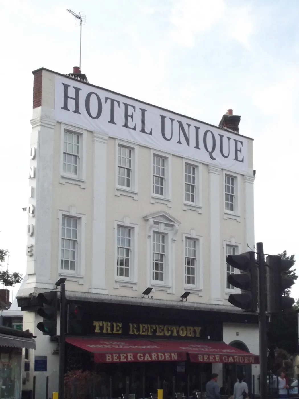 Hotel Unique, a three-storey cream building on Finchley Road, Golders Green, with the Refectory pub on the ground floor