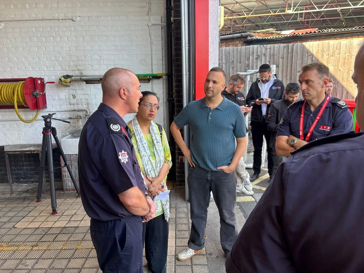 Fire Committee visitors with firefighters in the appliance bay at Finchley Road Fire Station